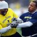 Lasker Smith goofs around with Zia Combs during the Victors Classic alumni football game at Michigan Stadium on Saturday. Melanie Maxwell I AnnArbor.com